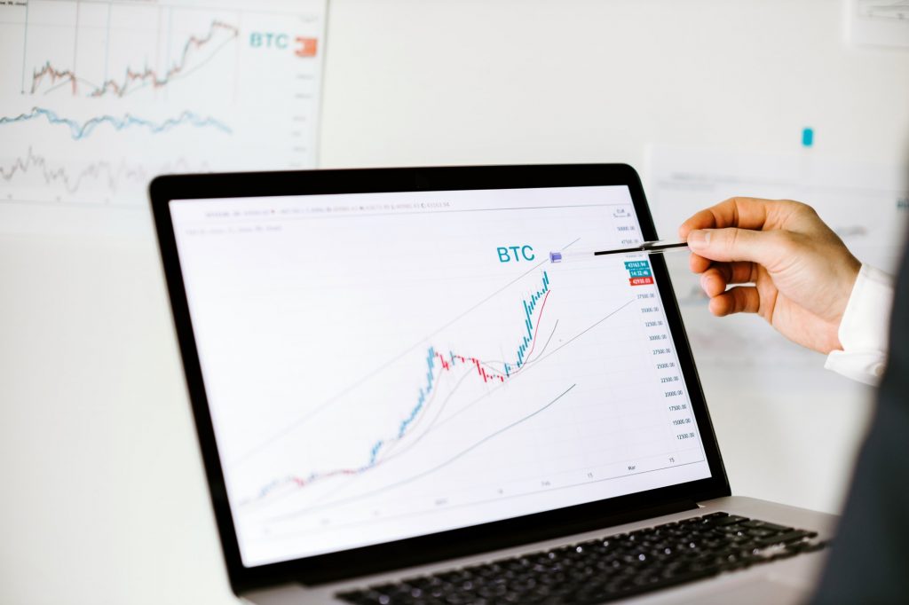 stock trader bitcoin price trend graph analysis on laptop